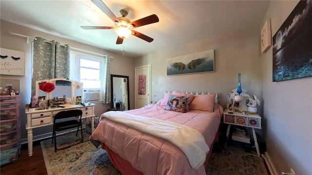 bedroom with ceiling fan and dark hardwood / wood-style floors