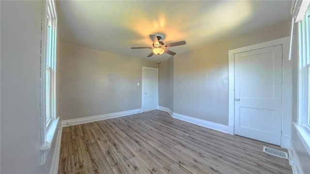 spare room featuring light wood-type flooring and ceiling fan