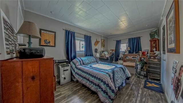 bedroom with crown molding and wood-type flooring