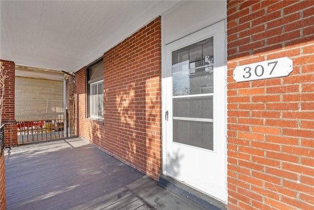 view of exterior entry with a porch