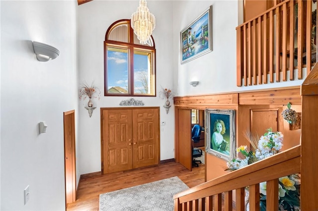 foyer with light hardwood / wood-style floors and a chandelier