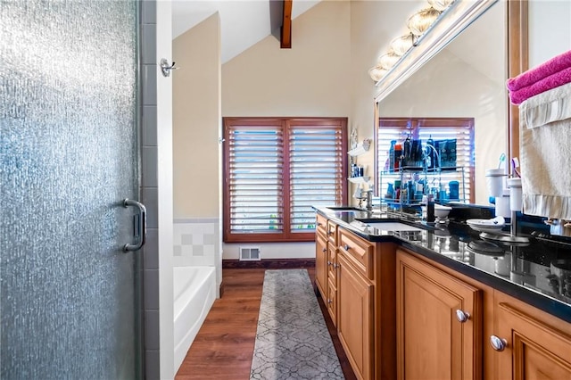 bathroom with vanity, lofted ceiling with beams, plus walk in shower, and wood-type flooring