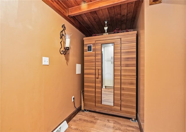 entryway featuring wood-type flooring, wooden ceiling, and beam ceiling