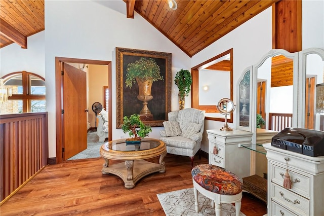 living area with beamed ceiling, plenty of natural light, light hardwood / wood-style floors, and wooden ceiling