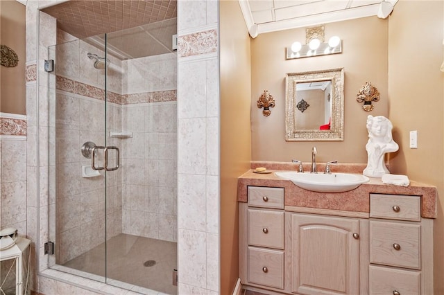 bathroom featuring vanity, an enclosed shower, and ornamental molding