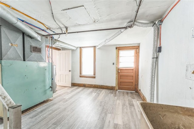 basement with hardwood / wood-style floors