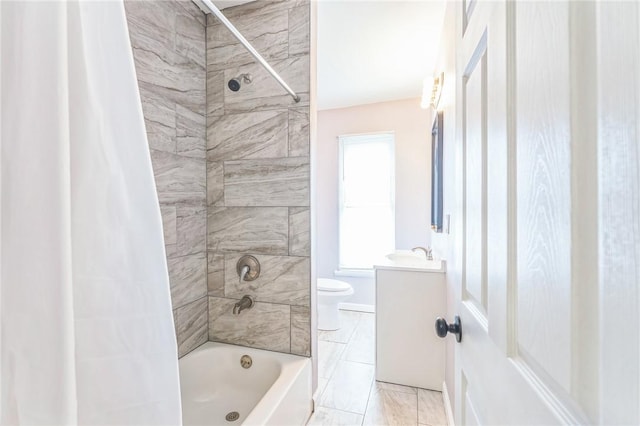 full bathroom featuring tile patterned floors, vanity, toilet, and tiled shower / bath