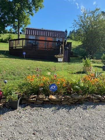 rear view of property with a yard and a deck