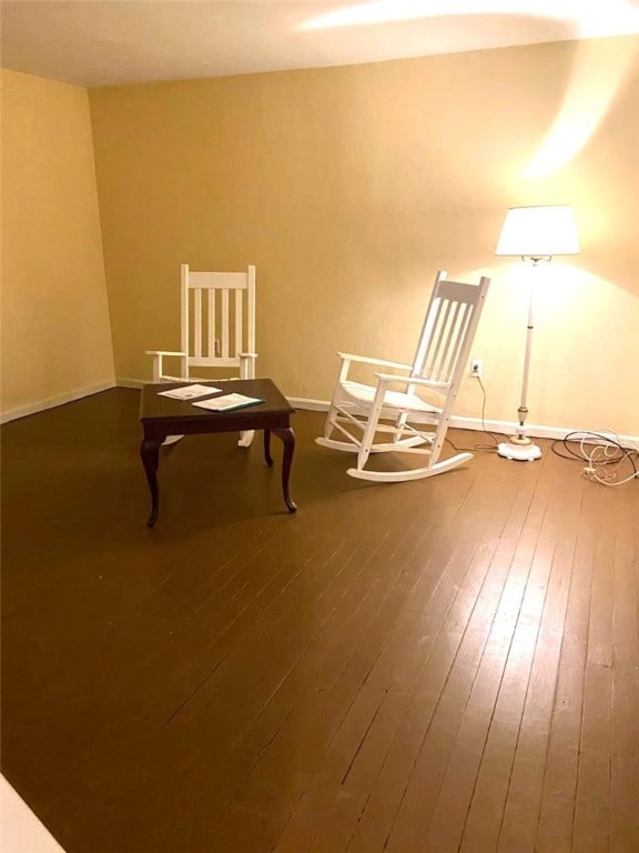 unfurnished room with dark wood-style flooring and baseboards