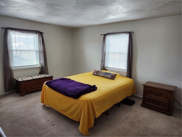 bedroom featuring light carpet