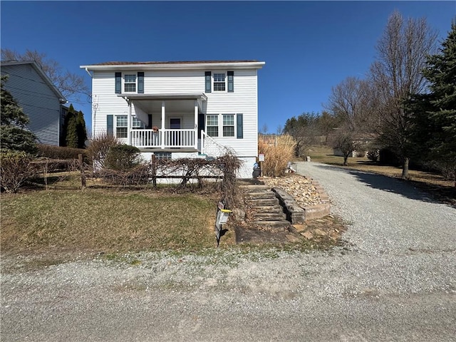 view of front facade with a porch and driveway