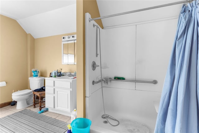 bathroom featuring vanity, lofted ceiling, tile patterned floors, a shower with curtain, and toilet