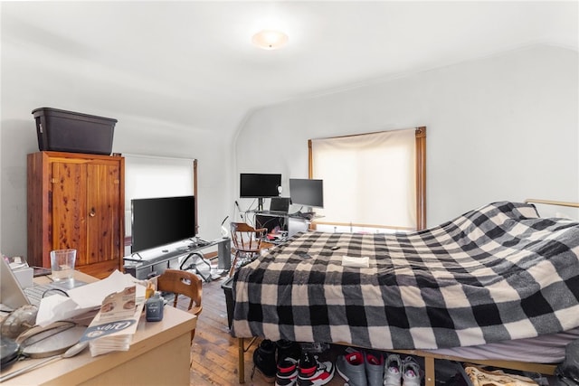 bedroom featuring vaulted ceiling and hardwood / wood-style flooring