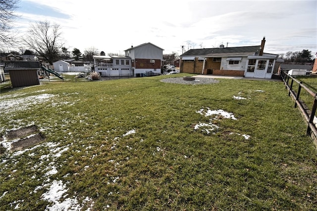 view of yard with a playground and a fire pit