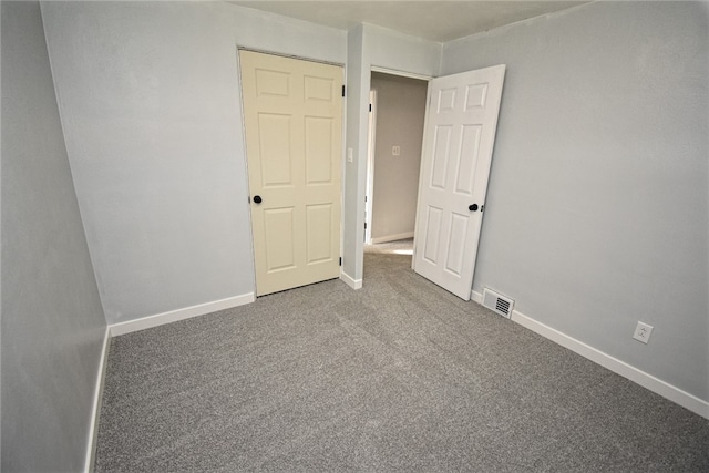 unfurnished bedroom with a closet and carpet floors