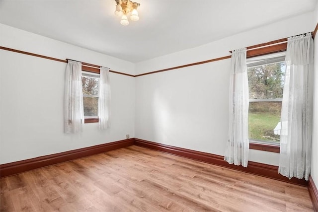 unfurnished room with light wood-type flooring