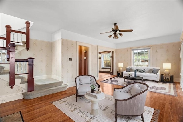 living room featuring ceiling fan and wood-type flooring