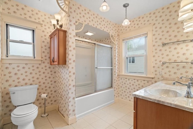 full bathroom featuring plenty of natural light, tile patterned flooring, bath / shower combo with glass door, and toilet