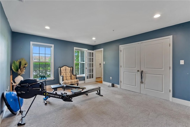 exercise room with light colored carpet