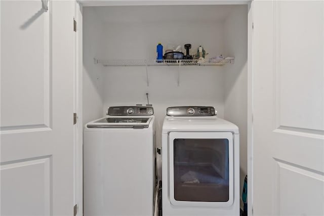 clothes washing area featuring independent washer and dryer