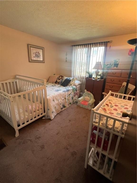 bedroom with carpet floors and a textured ceiling