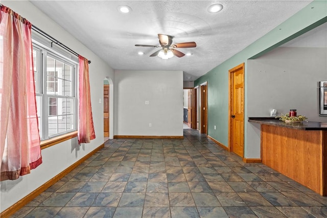 spare room with ceiling fan and a textured ceiling