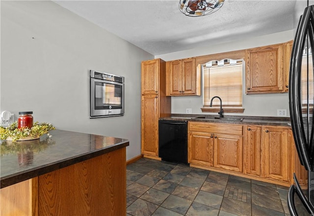 kitchen featuring a textured ceiling, sink, and black appliances