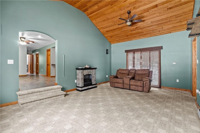 living room with light carpet, high vaulted ceiling, a stone fireplace, and wooden ceiling