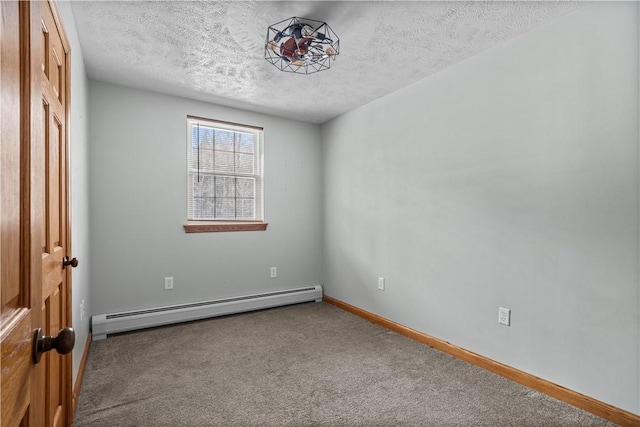 unfurnished room featuring carpet floors, a textured ceiling, and a baseboard heating unit