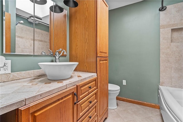 bathroom featuring tile patterned floors, vanity, and toilet