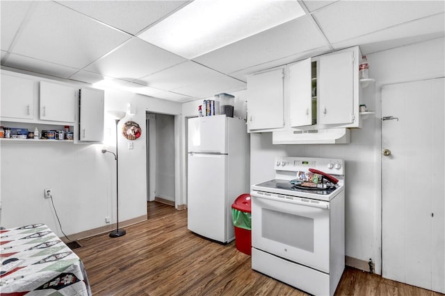 kitchen featuring a paneled ceiling, dark hardwood / wood-style flooring, white cabinets, and white appliances