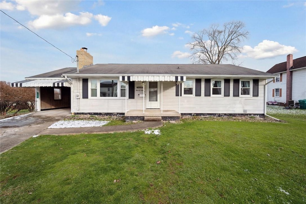 single story home with a front lawn and a carport