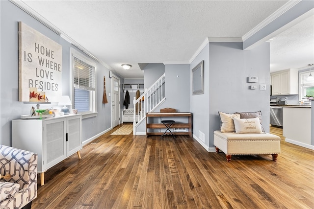 living area featuring dark hardwood / wood-style floors, crown molding, and a textured ceiling