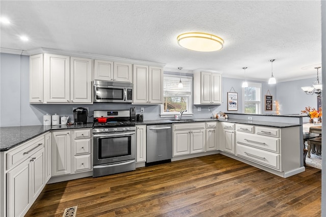 kitchen with a healthy amount of sunlight, white cabinets, and stainless steel appliances