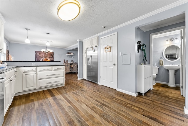 kitchen with white cabinets, stainless steel appliances, dark hardwood / wood-style floors, and hanging light fixtures