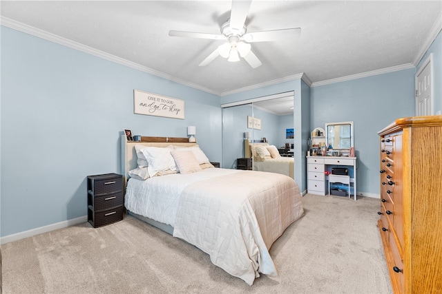 bedroom with crown molding, ceiling fan, a closet, and light carpet