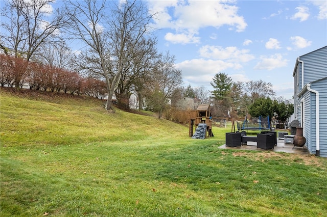 view of yard featuring a playground, a patio, a trampoline, and central AC unit