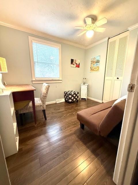 living area with dark hardwood / wood-style floors, ceiling fan, and crown molding