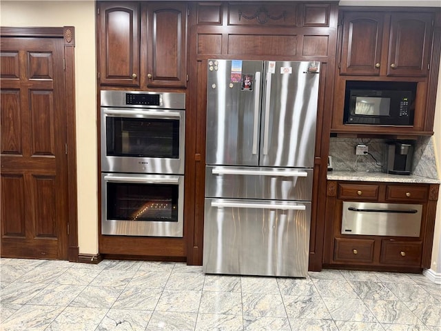 kitchen featuring tasteful backsplash, light stone countertops, and stainless steel appliances