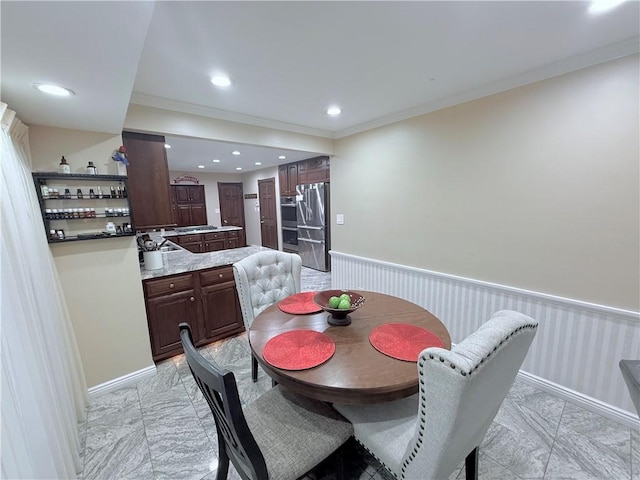 dining space with crown molding