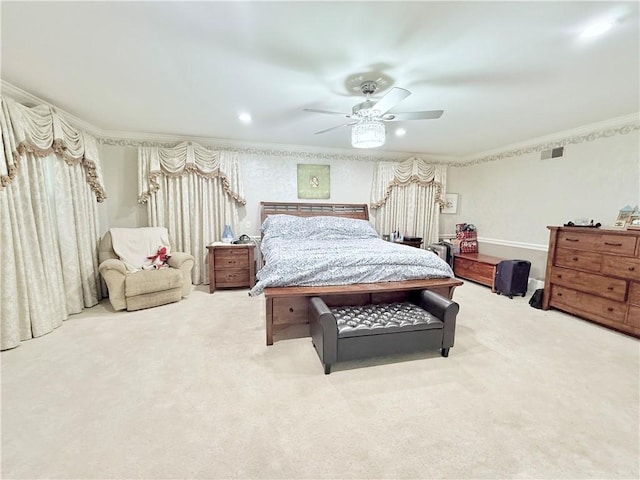 carpeted bedroom featuring ceiling fan and ornamental molding