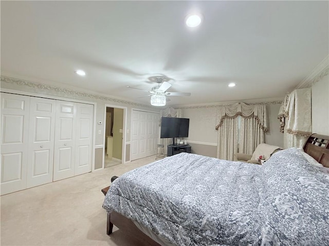 carpeted bedroom featuring ceiling fan and crown molding