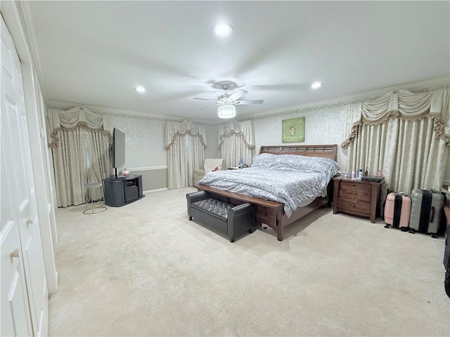 carpeted bedroom with ceiling fan and crown molding