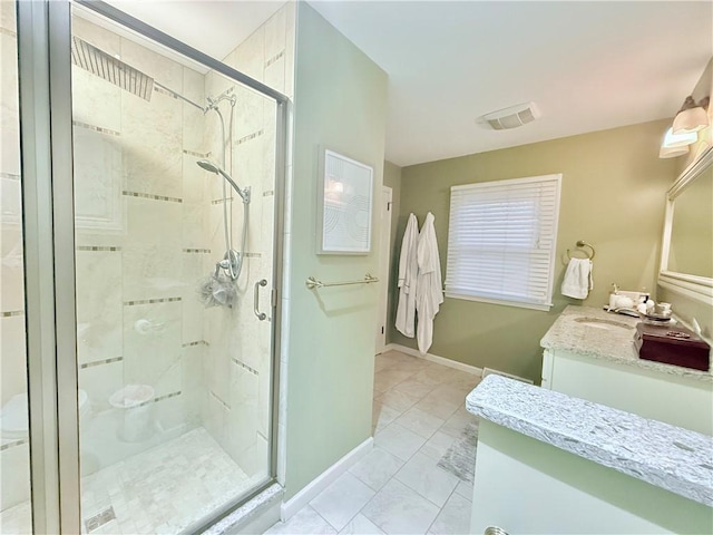 bathroom featuring vanity and a shower with shower door