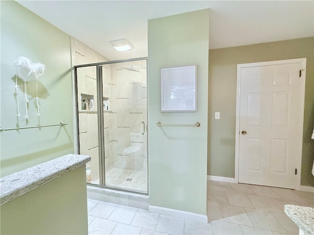 bathroom with tile patterned floors and a shower with shower door