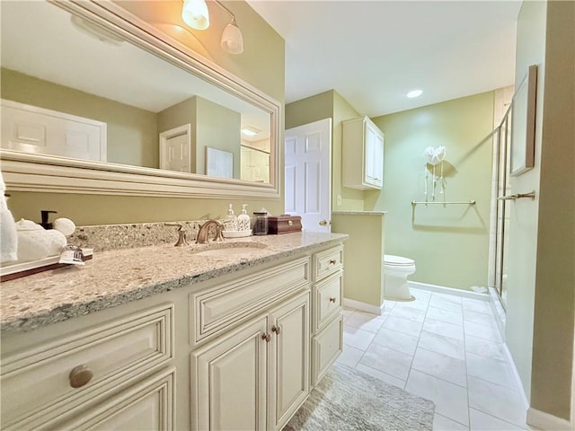 bathroom with tile patterned floors, vanity, an enclosed shower, and toilet