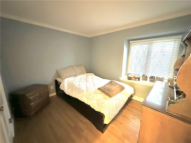 bedroom with wood-type flooring and crown molding