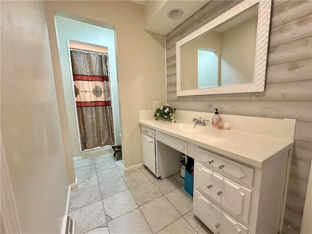 bathroom featuring wooden walls and vanity