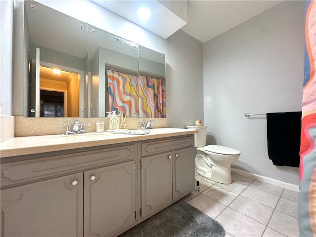 bathroom with tile patterned floors, vanity, and toilet