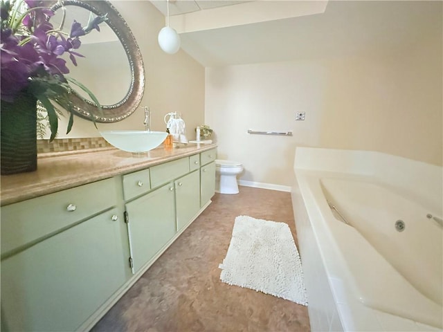 bathroom with vanity, toilet, and a bath